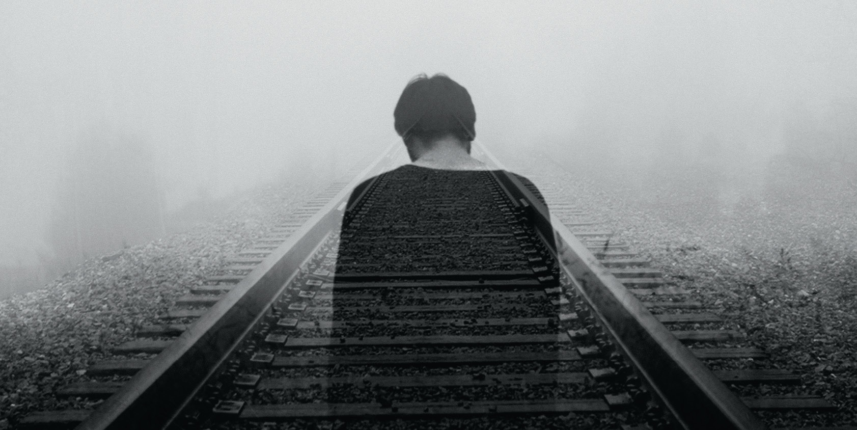 black and white silhouette of woman overlayed with train tracks