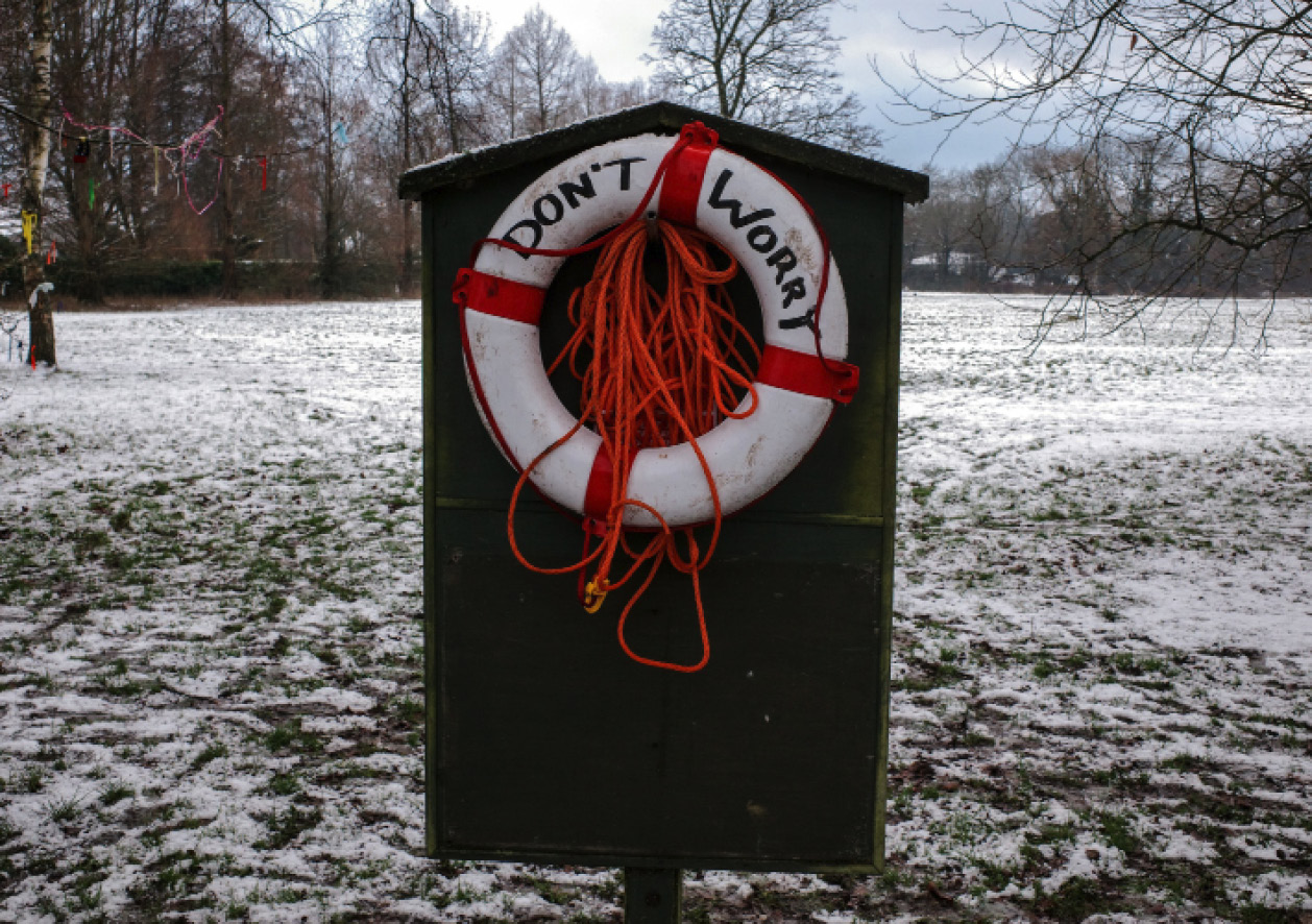 Don't Worry sign in winter with life saver floatation ring