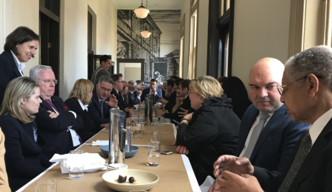 Barristers eating lunch together at a long table