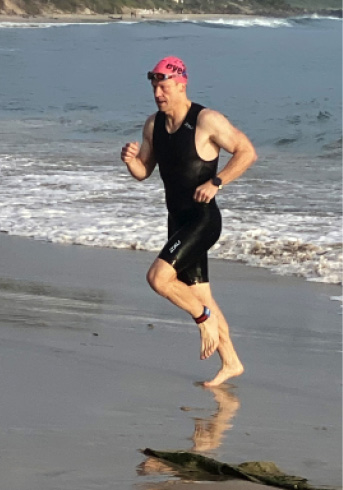 image of Peter Newton running on beach